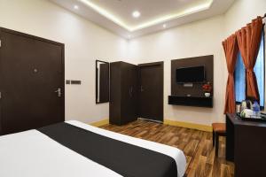 加尔各答OYO Hotel sakina的一间酒店客房,配有一张床和一台电视