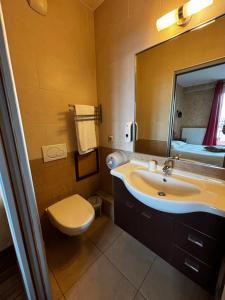 孔夫朗-圣奥诺里讷巴塞罗奥酒店的一间带水槽、卫生间和镜子的浴室