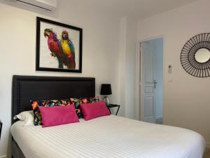 圣拉斐尔Villa 418的卧室配有一张床铺,墙上有两只鸟