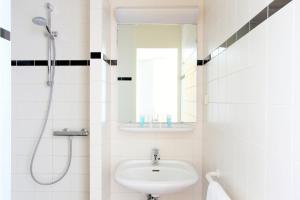 海尔伦巴斯迪恩海尔伦酒店的白色的浴室设有水槽和淋浴。