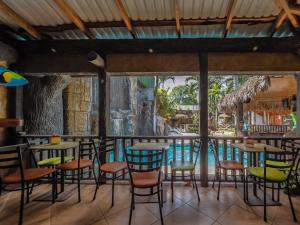 福尔图纳Poshtel Arenal的池畔酒吧配有桌椅