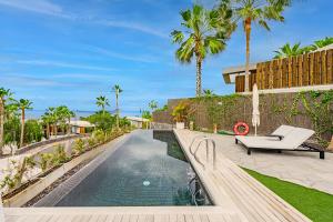 圣胡安海滩Stunning Sunsets Abama的一座别墅,设有游泳池和棕榈树