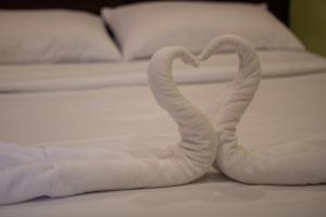 杜马格特Kayong's Inn的床上的两条毛巾形成心