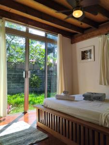 TemaeTema'e Beach House的一间卧室设有一张床和一个大型滑动玻璃门