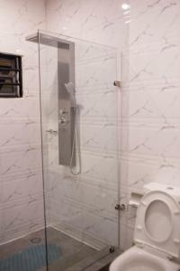 库马西Sleek Luxury Homes的浴室设有玻璃淋浴间和卫生间