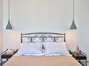 纳乌萨Villa Maria - Naoussa Squares Blue & Gold Suite的一间卧室,配有带2个床头柜的床