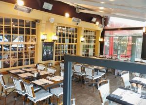 翁弗勒尔叠水瀑布 – 迷人酒店的餐厅内带桌椅的用餐室
