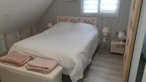 DannesEPICETOUT的一间卧室配有带白色床单和粉红色毛巾的床