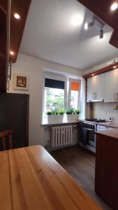 乌斯特卡Apartament Baltic Ustka的厨房配有木桌和窗户。