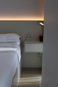 沙迦1 BR Luxury Apt by AJ Aljada的一间卧室,配有一张带两杯架子的床