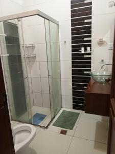圣克鲁斯Guajira Hostel SCZ的带淋浴、卫生间和盥洗盆的浴室