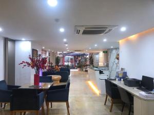 河内A25 Hotel - 12 Ngô Sỹ Liên的一间带桌椅的餐厅和一间酒吧