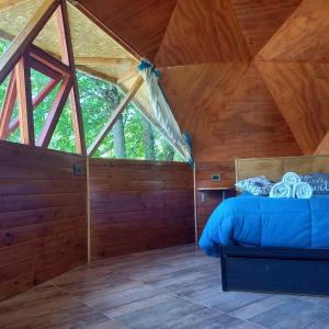 普埃洛湖Puelo EnDomos的小木屋内一间卧室,配有一张床