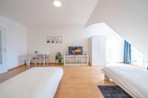 布兰肯费尔德Nice Apartment in Blankenfelde-Mahlow的白色的客房配有两张床和电视。