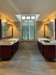琅勃拉邦PHA NYA RESIDENCE的浴室设有2个水槽和2面镜子
