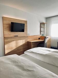 韦默尔斯基兴Hotel-Restaurant Zum Schwanen的酒店客房设有两张床和一台平面电视。