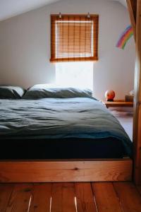 新扎姆基Domček的卧室内的一张床位,铺有木地板