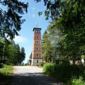 StützengrünBerggasthof Kuhberg的坐在路边的高高的砖塔