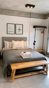 布宜诺斯艾利斯Amazing Apartment in Palermo Hollywood!的一间卧室配有一张大床,旁边设有木凳