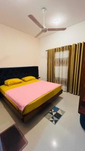 GonapolaMACA Canterbury Apartment的一间卧室配有一张大床,铺有黄色和粉色的床单。