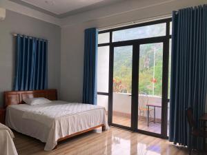 峰牙Nam Anh Hotel的一间卧室设有一张床和一个大窗户