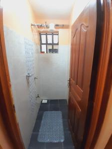纳库鲁JAYDE COSSY HOMES的带淋浴的小浴室和门