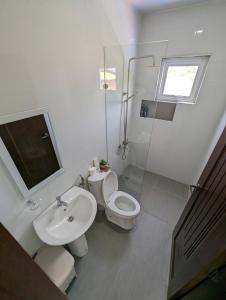 公主港OYO 1063 Manuela's Suites的白色的浴室设有卫生间和水槽。