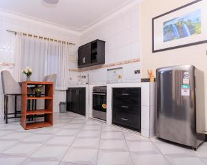 坎帕拉Greenwoods Apartments的厨房配有不锈钢冰箱和电器
