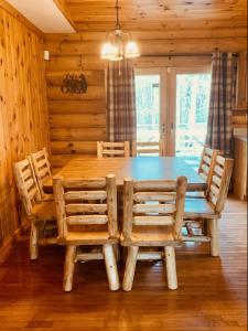SigelThe Forest Edge Cabin的一间带木桌和椅子的用餐室