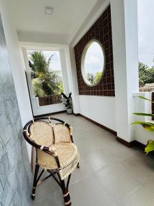贾夫纳Matheera holiday home的走廊上的藤椅,带圆形窗户