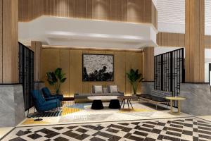 当格浪雅高酒店集团管理的班达拉国际酒店的大堂配有沙发和桌椅