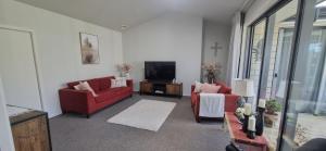 坎布里奇Cambridge Retreat的客厅配有2张红色沙发和1台电视