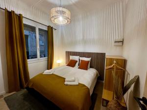 卡西斯LE PETIT PECHEUR DE CASSIS的一间卧室配有一张带橙色枕头的大床