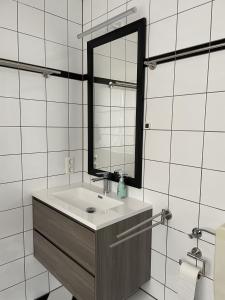 门兴格拉德巴赫Appartement mitten in der Stadt的一间带水槽和镜子的浴室