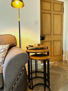 海伦斯堡The Gate Lodge的客厅配有桌子、沙发和台灯