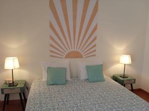 赞布热拉-杜马尔Hakuna Matata Hostel的一间卧室配有一张带枕头的床和两盏灯。