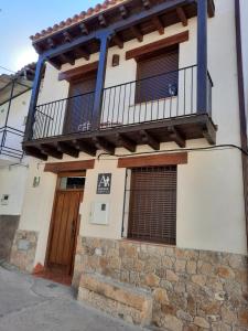 卡米诺新村La Casa de Mi Abuela的带阳台和门的建筑