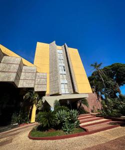 隆德里纳苏门答腊岛会议中心酒店的一座棕榈树的黄色建筑