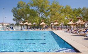 勒格罗-迪鲁瓦Camping Vagues Océanes的度假村的游泳池,配有椅子和遮阳伞