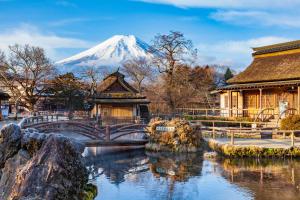 山中湖村Fuji Yamanakako Hotel的一座日本寺庙,背景是一座白雪山