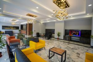 帕莫卡莱Çelik Thermal & Spa的大堂配有色彩缤纷的家具和电视。