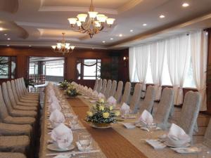 波来古市HAGL Hotel Gia Lai的长长的用餐室配有长桌子和椅子
