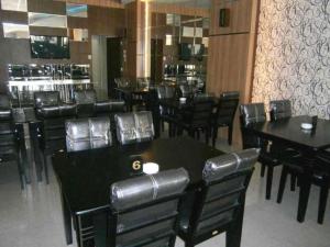 ParitBenteng Hotel Pekanbaru的用餐室配有黑色的桌椅