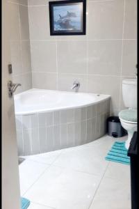 马盖特Indigo Bay 29的带浴缸和卫生间的浴室。