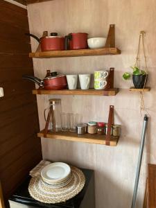 塔夸伦博La Casita的厨房配有木制架子、锅碗瓢盆