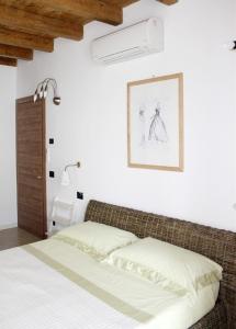 布雷西亚拉费兰达酒店的卧室配有一张床,墙上挂着一幅画