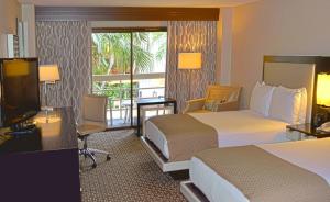 休斯顿休斯顿霍比机场希尔顿酒店的酒店客房设有两张床和电视。