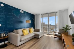 哈兰代尔海滩Infinite View with Balcony,Pool plus Near Beach的带沙发和蓝色墙壁的客厅