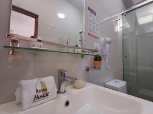 帕拉卡斯Arena Hostal的白色的浴室设有水槽和镜子