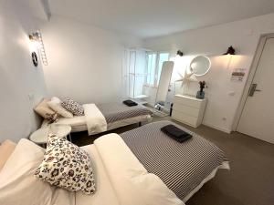 阿利坎特Hola Hostel Alicante的小房间设有两张床和镜子
